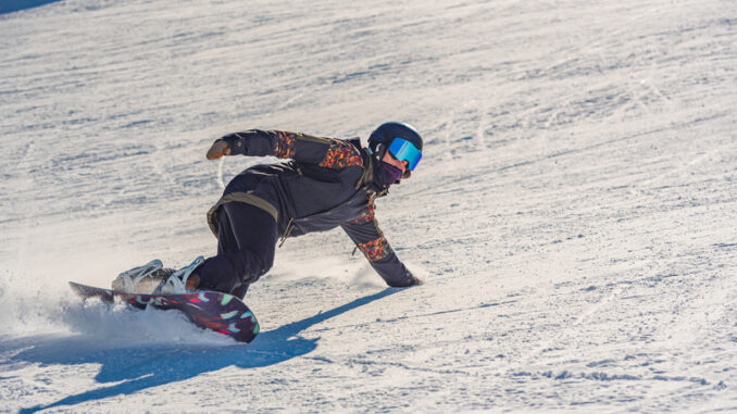 a person snowboarding down a slope